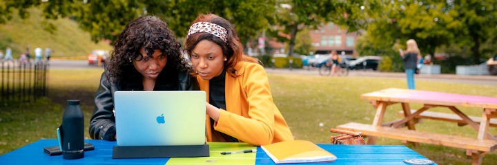 two girls looking at a laptop